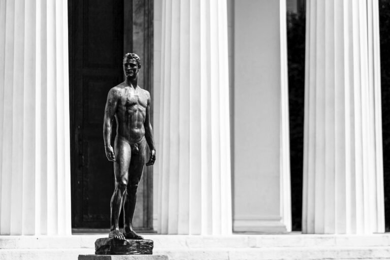 Grayscale Photography of Nude Man Standing Statue